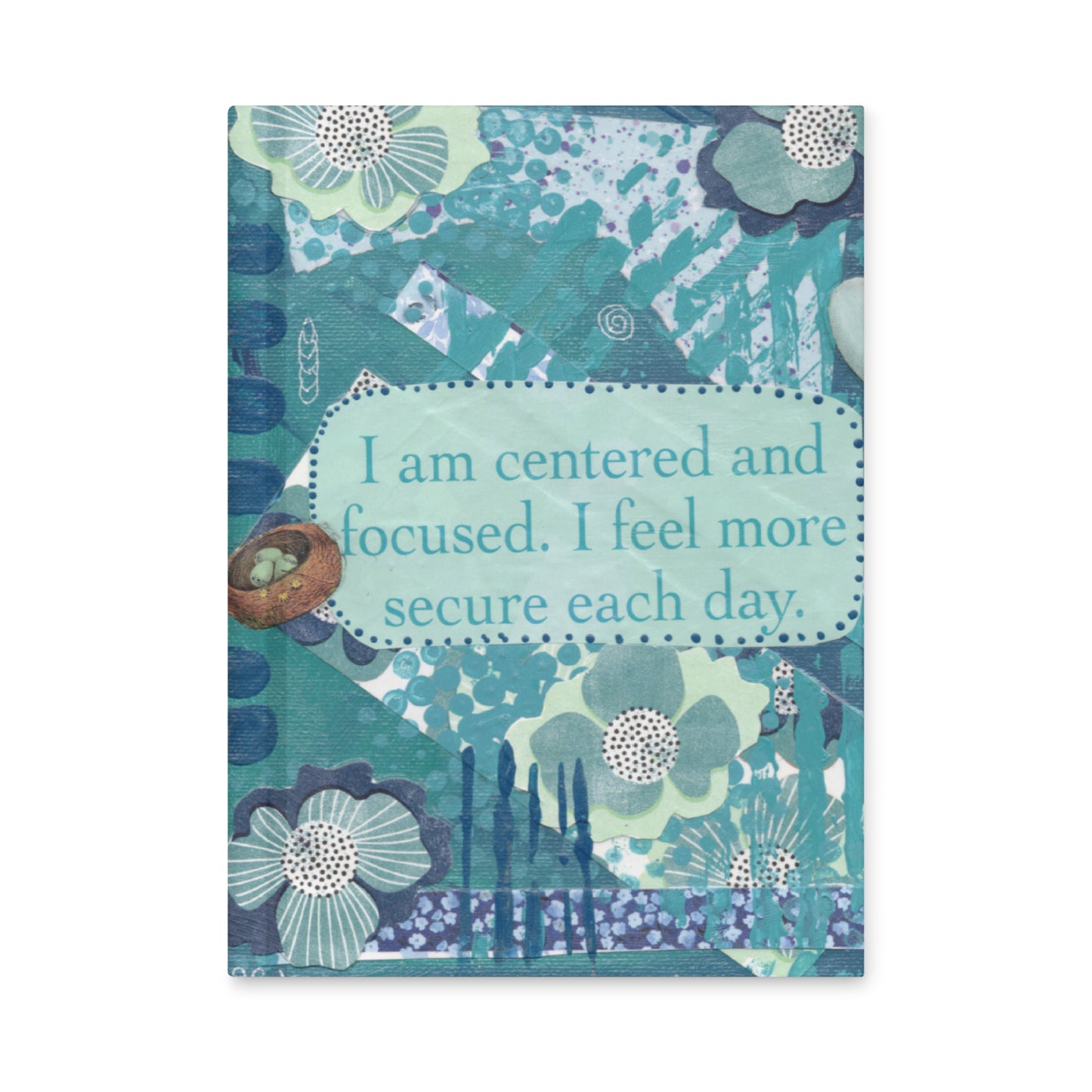 The front cover of a blue floral hardcover journal  has blue flowers with a blue text box in middle that says "I am centered and focused. I feel more secure each day".