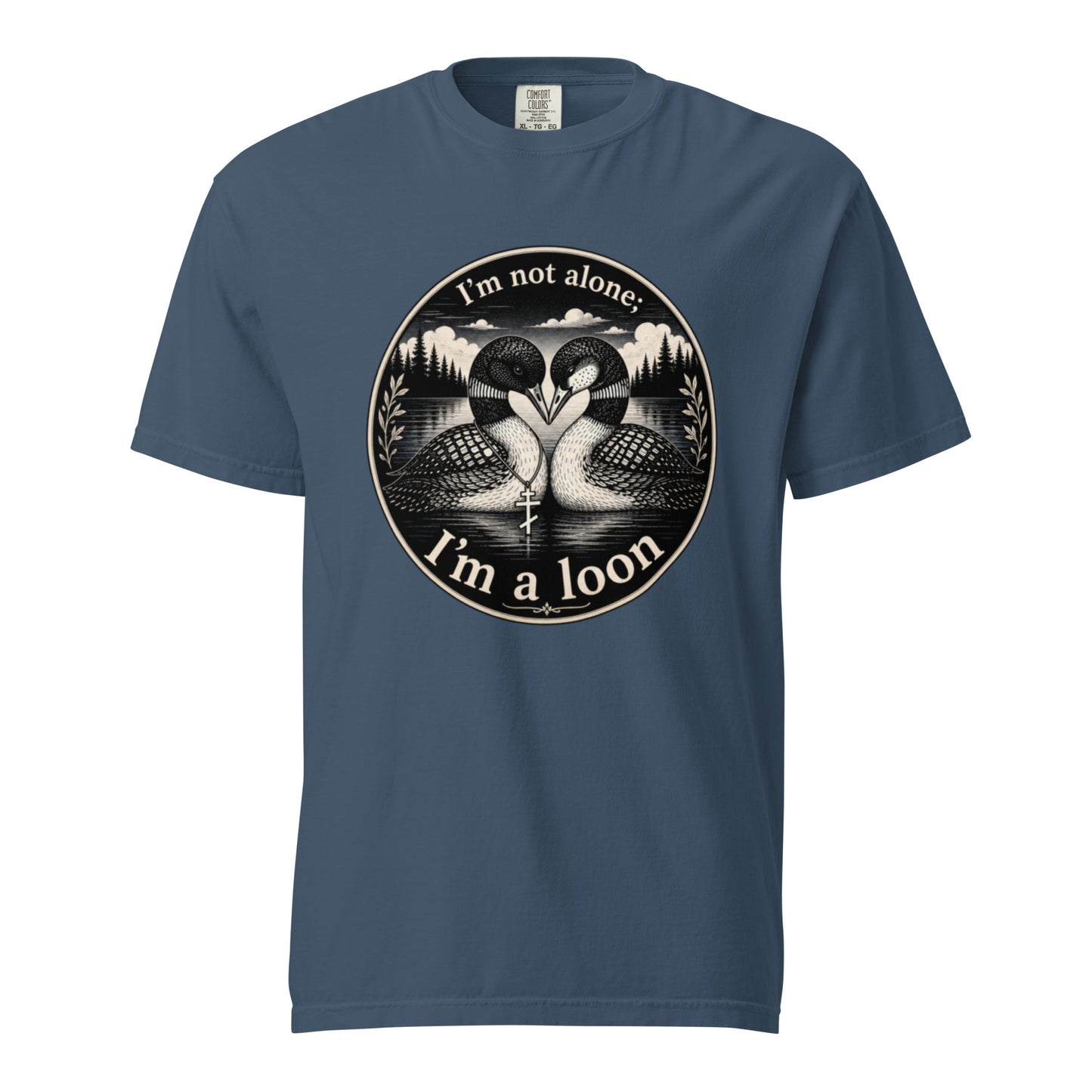 A Midnight colored short-sleeve crewneck t-shirt featuring a circular black and white graphic of two loons facing each other in front of a lake and mountains, with the text 'I'm not alone. I'm a loon'.