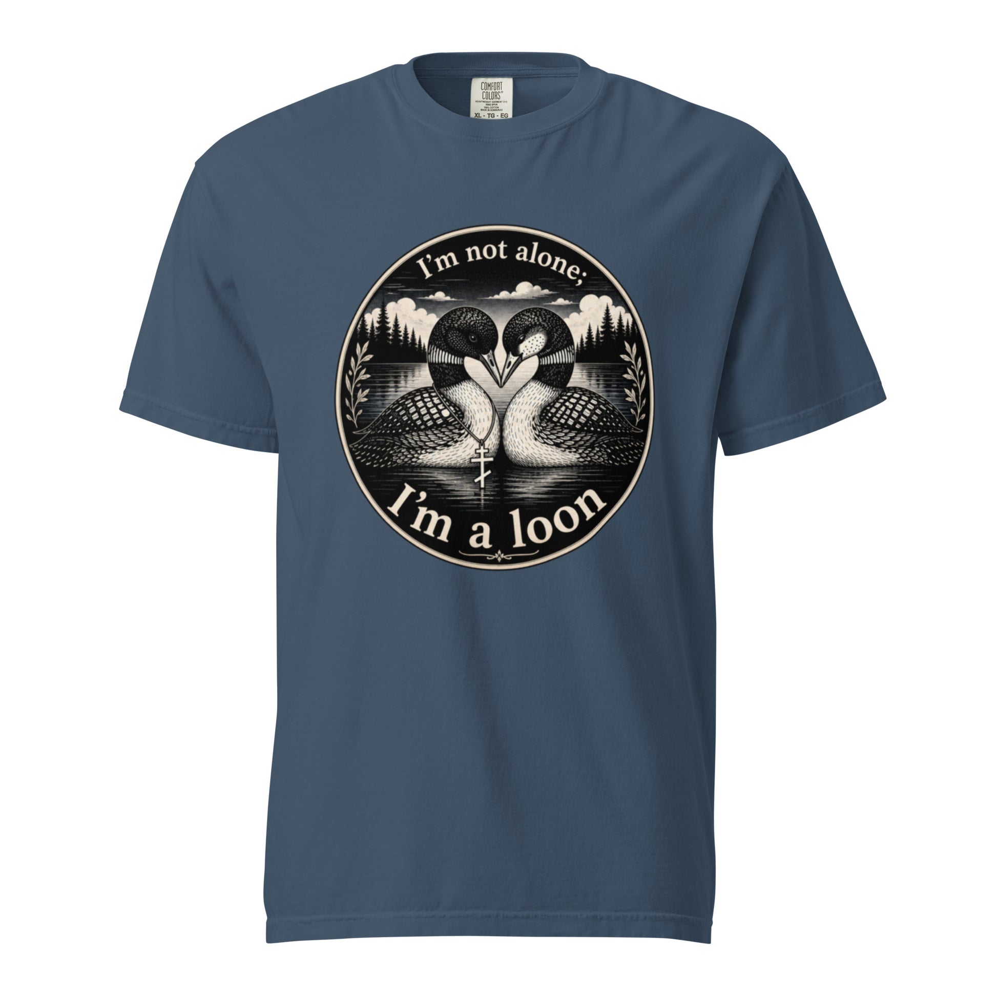 A Midnight colored short-sleeve crewneck t-shirt featuring a circular black and white graphic of two loons facing each other in front of a lake and mountains, with the text 'I'm not alone. I'm a loon'.