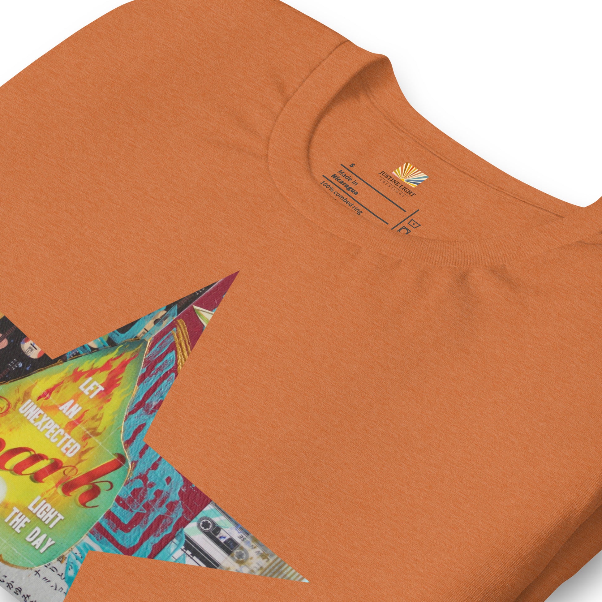 details of Star tee shirt with a colorful mixed-media star design and the words spark of inspiration on a soft unisex t shirt.
