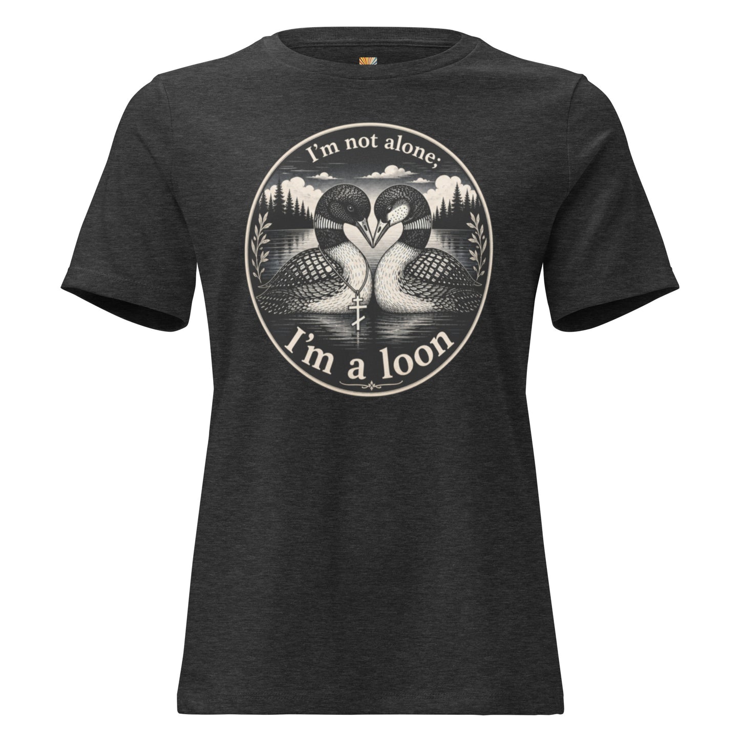 A graphic tee for women in dark heather gray, crewneck featuring a circular graphic print of two loons facing each other in water, with the text 'I'm not alone; I'm a loon' arched above and below the illustration.
