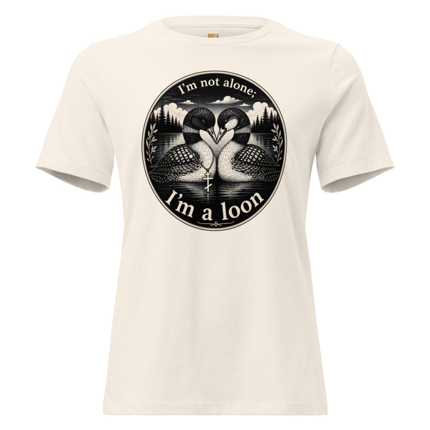 A natural colored short-sleeve crewneck t-shirt featuring a circular black graphic print of two loons facing each other in water, with the text 'I'm not alone; I'm a loon' arched above and below the illustration.
